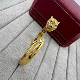 Cartier open-style cuff bracelet featuring a diamond-set panther head and spotted motif.